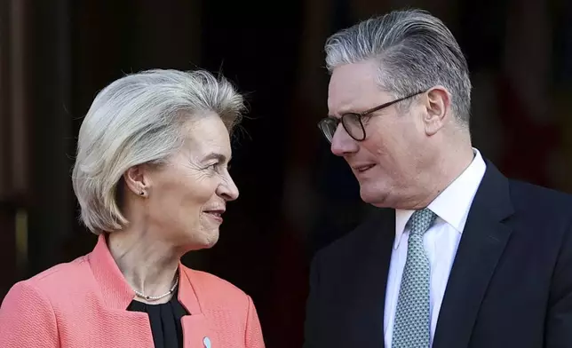 Britain's Prime Minister Keir Starmer, right, welcomes European Commission President Ursula von der Leyen to the European leaders' summit to discuss Ukraine, at Lancaster House, London, Sunday March 2, 2025. (Toby Melville/Pool via AP)
