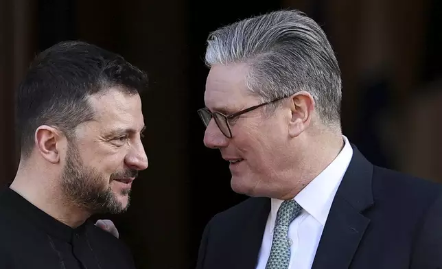 Britain's Prime Minister Keir Starmer, right, welcomes Ukrainian President Volodymyr Zelenskyy to the European leaders' summit to discuss Ukraine, at Lancaster House, London, Sunday March 2, 2025. (Toby Melville/Pool via AP)