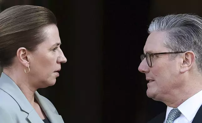 Britain's Prime Minister Keir Starmer, right, welcomes Denmark's Prime Minister Mette Frederiksen to the European leaders' summit to discuss Ukraine, at Lancaster House, London, Sunday March 2, 2025. (Toby Melville/Pool via AP)