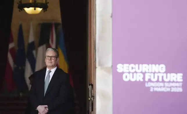Britain's Prime Minister Keir Starmer waits in a doorway for arrivals during a summit on Ukraine at Lancaster House in London, Sunday, March 2, 2025. (AP Photo/Christophe Ena, Pool)