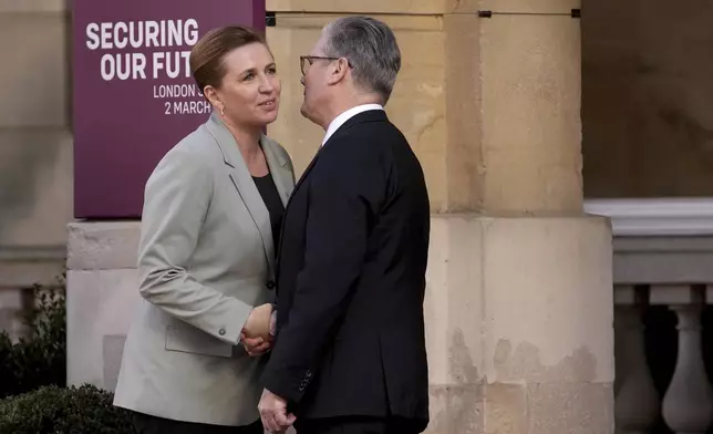 Britain's Prime Minister Keir Starmer, right, greets Denmark's Prime Minister Mette Frederiksen as she arrives for a summit on Ukraine at Lancaster House in London, Sunday, March 2, 2025. (AP Photo/Christophe Ena, Pool)