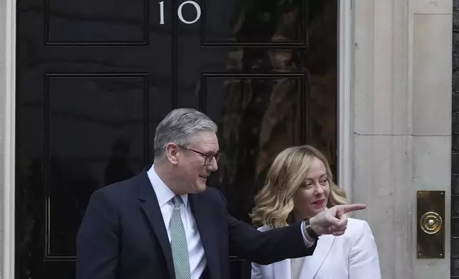 Britain's Prime Minister Keir Starmer gestures as he poses for the media with Italy's Prime Minister Giorgia Meloni on the doorstep of 10 Downing Street in London, Sunday, March 2, 2025. (AP Photo/Frank Augstein)