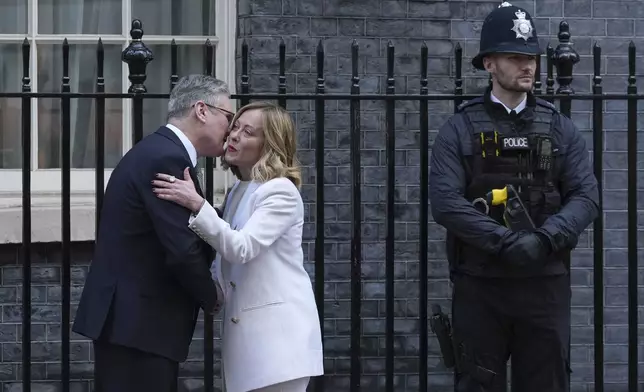 Britain's Prime Minister Keir Starmer greets Italy's Prime Minister Giorgia Meloni as she arrives for a meeting at 10 Downing Street in London Sunday, March 2, 2025. (AP Photo/Frank Augstein)
