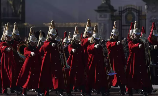 Members of the Household Cavalry band march past Buckingham Palace and close to Lancaster House where Britain's Prime Minister Keir Starmer will chair a Ukraine Summit with leaders from Europe and Canada in London, Sunday, March 2, 2025. (AP Photo/Alberto Pezzali)