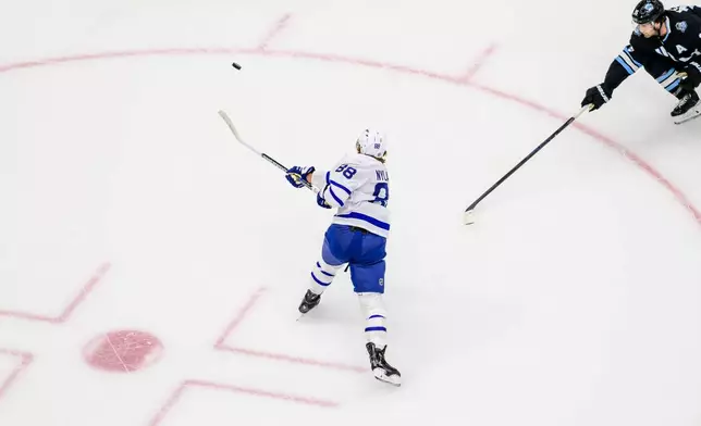 Toronto Maple Leafs right wing William Nylander (88) shoots in the first period for the first goal of an NHL hockey game against the Utah Hockey Club, Monday, March 10, 2025, in Salt Lake City. (AP Photo/Tyler Tate)