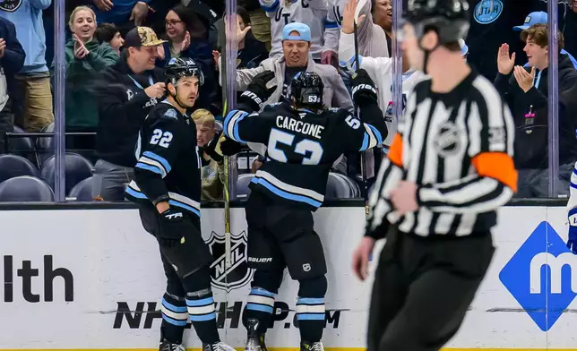 Utah Hockey Club left wing Michael Carcone (53) celebrates scoring a goal with Utah Hockey Club team owner Ryan Smith during the second period of an NHL hockey game against the Toronto Maple Leafs, Monday, March 10, 2025, in Salt Lake City. (AP Photo/Tyler Tate)