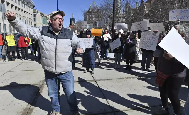 Patrick Festa chants in support of the National Park Service at a "Save Steamtown" rally to protest the Trump administration layoffs at the Steamtown National Historic Site in Scranton, Pa., Saturday, Feb. 22, 2025. (Aimee Dilger/WVIA via AP)