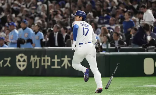 Los Angeles Dodgers' Shohei Ohtani runs out a fly out to left in the first inning of an MLB Tokyo Series baseball game against the Chicago Cubs in Tokyo, Japan, Wednesday, March 19, 2025. (AP Photo/Eugene Hoshiko)