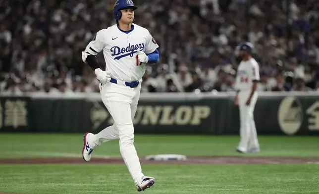 Los Angeles Dodgers' Shohei Ohtani jogs to the dugout after flying out to left in the first inning of an MLB Tokyo Series baseball game against the Chicago Cubs in Tokyo, Japan, Wednesday, March 19, 2025. (AP Photo/Eugene Hoshiko)