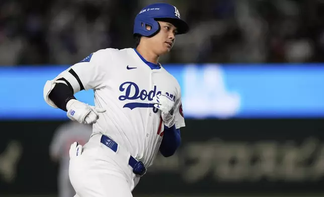 Los Angeles Dodgers' Shohei Ohtani rounds the bases after hitting a solo home run in the fifth inning of an MLB Tokyo Series baseball game against the Chicago Cubs in Tokyo, Japan, Wednesday, March 19, 2025. (AP Photo/Eugene Hoshiko)
