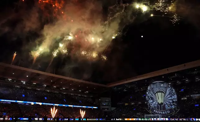 Fireworks explode over Villa Park before the Champions League round of 16 second leg soccer match between Aston Villa and Club Brugge at the Villa Park stadium in Birmingham, England, Wednesday, March 12, 2025. (Nick Potts/PA via AP)