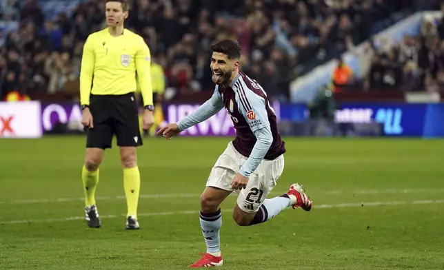 Aston Villa's Marco Asensio celebrates after scoring opening goal during the Champions League round of 16 second leg soccer match between Aston Villa and Club Brugge at the Villa Park stadium in Birmingham, England, Wednesday, March 12, 2025. (Jacob King/PA via AP)