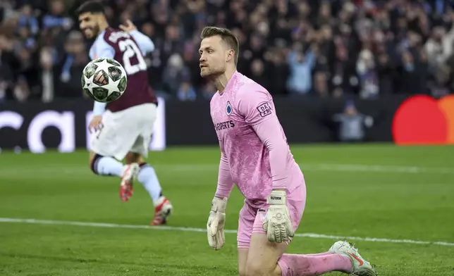 Brugge's goalkeeper Simon Mignolet, front, reacts after Aston Villa's Marco Asensio scoring his side's third goal during the Champions League round of 16 second leg soccer match between Aston Villa and Club Brugge at the Villa Park stadium in Birmingham, England, Wednesday, March 12, 2025. (AP Photo/Darren Staples)