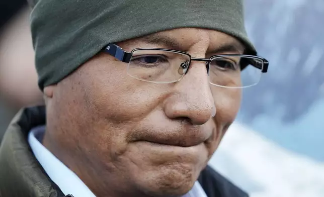 Peruvian farmer Luciano Lliuya arrives at the Higher Regional Court in Hamm, Germany, for a first hearing of his climate damages case against the German energy company RWE for its carbon emissions, which may have been contributing to the melting of a nearby glacier that could flood his home, Monday, March 17, 2025. (AP Photo/Martin Meissner)