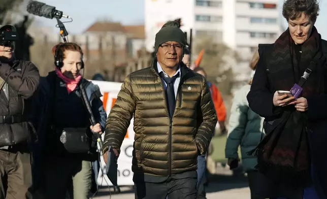 Peruvian farmer Luciano Lliuya arrives at the Higher Regional Court in Hamm, Germany, for a first hearing of his climate damages case against the German energy company RWE for its carbon emissions, which may have been contributing to the melting of a nearby glacier that could flood his home, Monday, March 17, 2025. (AP Photo/Martin Meissner)