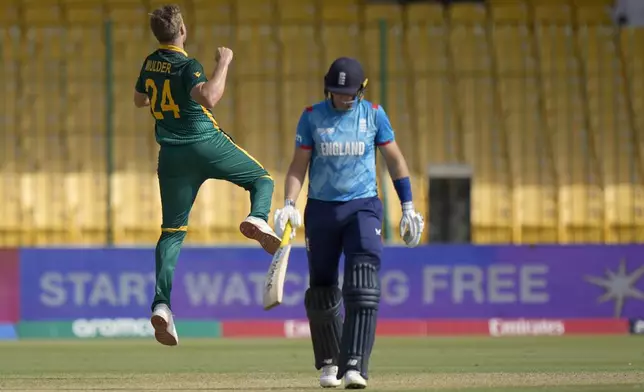 South Africa's Wiaan Mulder, left, celebrates after taking the wicket of England's Joe Root, right, during the ICC Champions Trophy cricket match between England and South Africa, in Karachi, Pakistan Saturday, March 1, 2025. (AP Photo/Anjum Naveed)