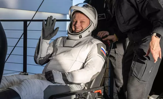 Russia’s Alexander Gorbunov waves after being helped out of a SpaceX capsule onboard the SpaceX recovery ship Megan after landing in the water off the coast of Tallahassee, Fla., Tuesday, March 18, 2025. (Keegan Barber/NASA via AP)