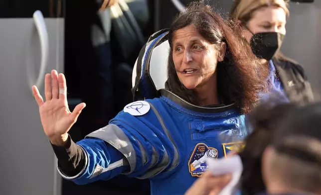 FILE - NASA astronaut Suni Williams waves to well wishers as she leaves the Operations and Checkout building before heading to Space Launch Complex 41 to board the Boeing's Starliner capsule atop an Atlas V rocket for a mission to the International Space Station at the Cape Canaveral Space Force Station, Monday, May 6, 2024, in Cape Canaveral, Fla. (AP Photo/John Raoux, File)
