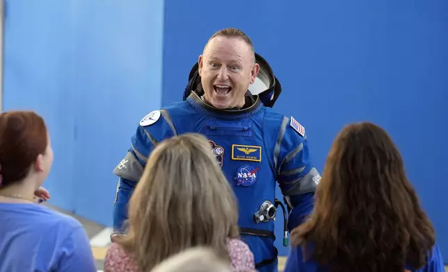 FILE - NASA astronaut Butch Wilmore talks to his family after leaving the operations and checkout building for a trip to launch pad at Space Launch Complex 41 Wednesday, June 5, 2024, in Cape Canaveral, Fla. (AP Photo/Chris O'Meara, File)