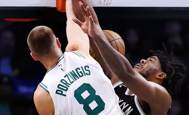 Boston Celtics center Kristaps Porzingis (8) dunks against during the second half of an NBA basketball game, Saturday, March 15, 2025, in New York. (AP Photo/Noah K. Murray)