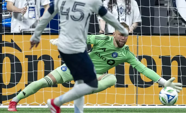 CF Montreal goalkeeper Jonathan Sirois, right, stops a kick by Vancouver Whitecaps' Pedro Vite (45) during the second half of an MLS soccer match in Vancouver, British Columbia, Saturday, March 8, 2025. (Ethan Cairns/The Canadian Press via AP)