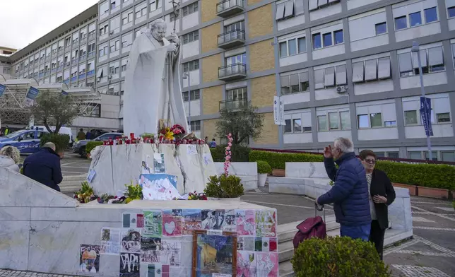 People pray for Pope Francis in front of the Agostino Gemelli Polyclinic, in Rome, Saturday, March 15, 2025, where the Pontiff is hospitalized since Feb. 14. (AP Photo/Andrew Medichini)