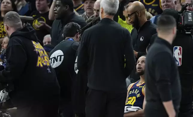 Golden State Warriors guard Stephen Curry (30) watches a video tribute in his honor after scoring his 4,000th career regular season 3-point basket during the second half of an NBA basketball game against the Sacramento Kings, Thursday, March 13, 2025, in San Francisco. (AP Photo/Godofredo A. Vásquez)