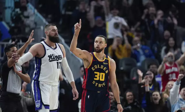 Golden State Warriors guard Stephen Curry (30) reacts after making a 3-point basket during the first half of an NBA basketball game against the Sacramento Kings, Thursday, March 13, 2025, in San Francisco. (AP Photo/Godofredo A. Vásquez)