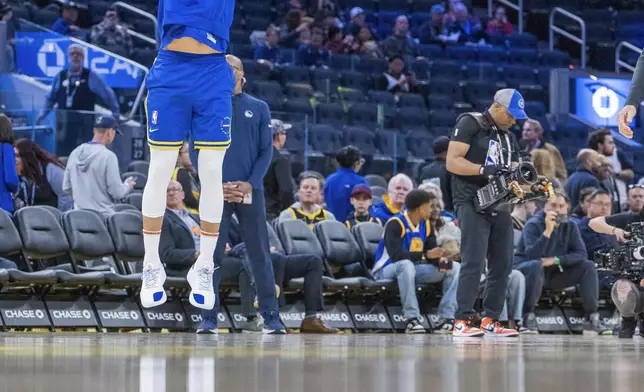 Golden State Warriors guard Stephen Curry warms up before an NBA basketball game against the Portland Trail Blazers in San Francisco, Monday, March 10, 2025. (AP Photo/Nic Coury)