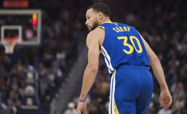 Golden State Warriors guard Stephen Curry looks on during the first half of an NBA basketball game against the Portland Trail Blazers in San Francisco, Monday, March 10, 2025. (AP Photo/Nic Coury)