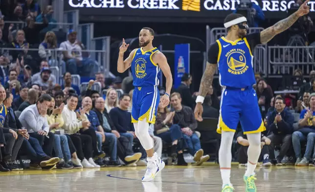 Golden State Warriors guard Stephen Curry (30) celebrates after scoring alongside guard Gary Payton II (0) during the first half of an NBA basketball game against the Portland Trail Blazers in San Francisco, Monday, March 10, 2025. (AP Photo/Nic Coury)