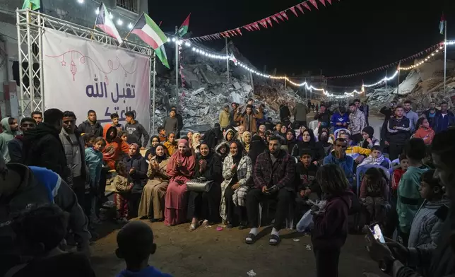 Palestinians gather to celebrate after iftar, the fast-breaking meal, on the first day of Ramadan in Rafah, southern Gaza Strip, Saturday, March 1, 2025 (AP Photo/Abdel Kareem Hana)