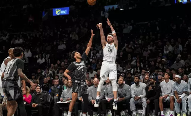 Dallas Mavericks guard Klay Thompson (31) attempts a three-pointer during the first half of an NBA basketball game against the Brooklyn Nets, Monday, March 24, 2025, in New York. (AP Photo/Angelina Katsanis)