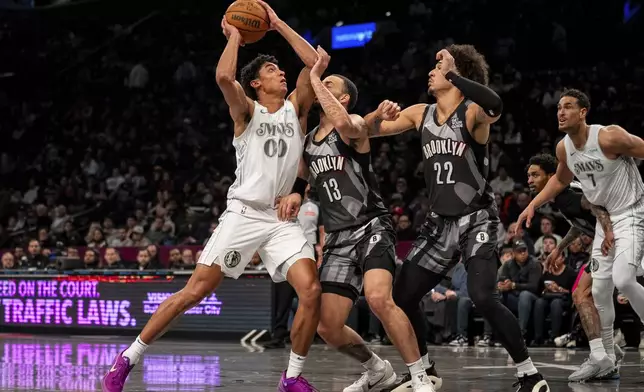 Dallas Mavericks guard Max Christie (00) searches for a basket during the first half of an NBA basketball game against the Brooklyn Nets, Monday, March 24, 2025, in New York. (AP Photo/Angelina Katsanis)