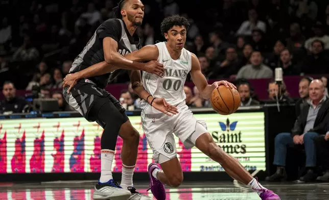 Dallas Mavericks guard Max Christie (00) pushes toward the basket during the first half of an NBA basketball game against the Brooklyn Nets, Monday, March 24, 2025, in New York. (AP Photo/Angelina Katsanis)