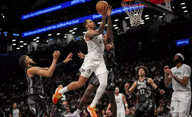 Dallas Mavericks forward P.J. Washington (25) makes a basket during the first half of an NBA basketball game against the Brooklyn Nets, Monday, March 24, 2025, in New York. (AP Photo/Angelina Katsanis)