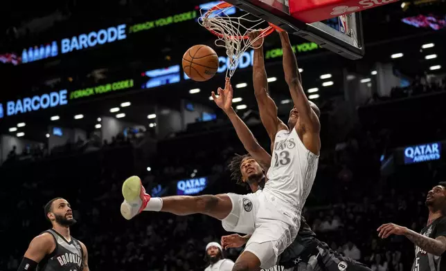 Dallas Mavericks forward Kai Jones (23) dunks during the first half of an NBA basketball game against the Brooklyn Nets, Monday, March 24, 2025, in New York. (AP Photo/Angelina Katsanis)