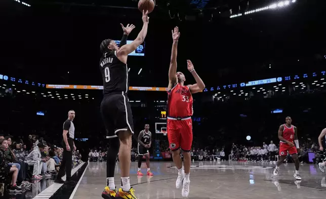 Brooklyn Nets' Trendon Watford (9) shoots over LA Clippers' Nicolas Batum (33) during the first half of an NBA basketball game Friday, March 28, 2025, in New York. (AP Photo/Frank Franklin II)