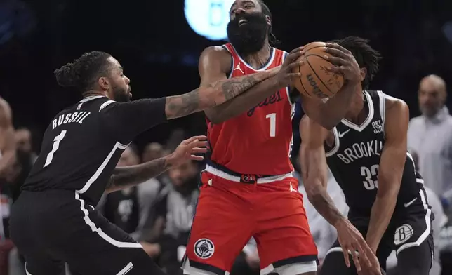 Brooklyn Nets' D'Angelo Russell (1) defends LA Clippers' James Harden (1) during the first half of an NBA basketball game Friday, March 28, 2025, in New York. (AP Photo/Frank Franklin II)