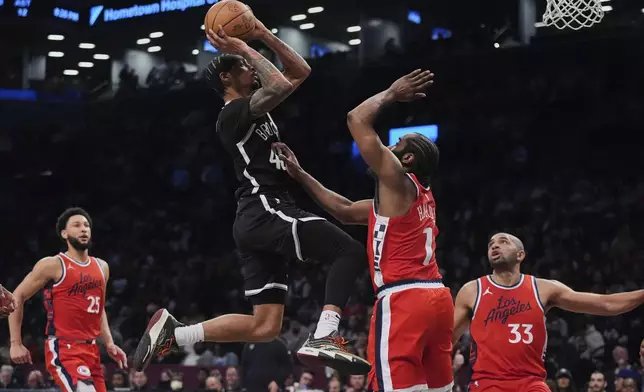 Brooklyn Nets' Keon Johnson (45) shoots over LA Clippers' James Harden (1) as LA Clippers' Nicolas Batum (33) and Ben Simmons (25) watch during the first half of an NBA basketball game Friday, March 28, 2025, in New York. (AP Photo/Frank Franklin II)