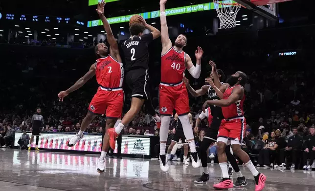 LA Clippers' Kawhi Leonard (2) and Ivica Zubac (40) defend Brooklyn Nets' Cameron Johnson (2) during the first half of an NBA basketball game Friday, March 28, 2025, in New York. (AP Photo/Frank Franklin II)