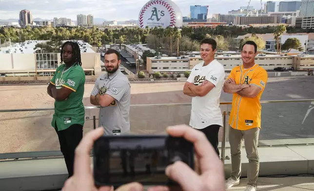 Athletics players, from left, Lawrence Butler, Shea Langeliers, Mason Miller and Brent Rooker pose for a photo as their team's logo is displayed on The Sphere during a press conference, Friday, March 7, 2025, in Las Vegas. (Wade Vandervort//Las Vegas Sun via AP)