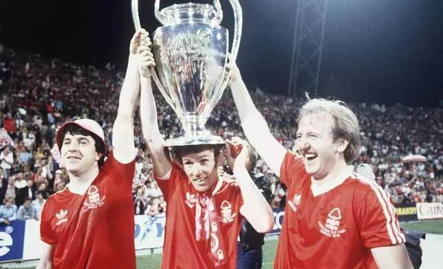 FILE - Nottingham Forest's John Robertson, left, Ian Bowyer, center, and Kenny Burns, right, carry the European Cup in triumph after their 1-0 win against Malmo FF in Munich, Germany, May 30, 1979. (AP Photo, File)