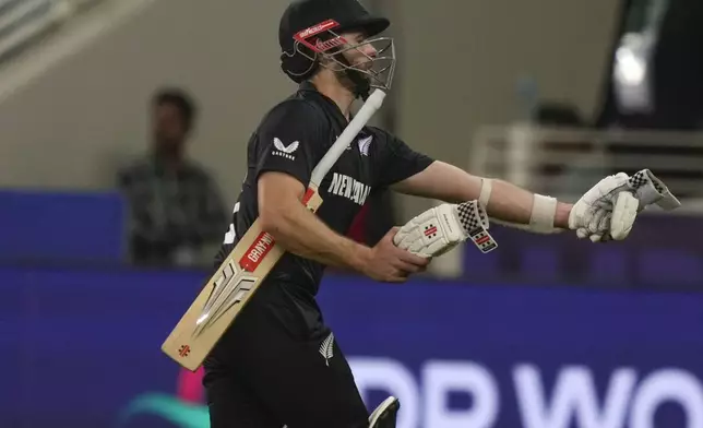 New Zealand's Kane Williamson leaves the ground after losing his wicket during the ICC Champions Trophy cricket match between India and New Zealand at Dubai International Cricket Stadium in Dubai, United Arab Emirates, Sunday, March 2, 2025. (AP Photo/Altaf Qadri )