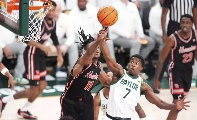 Houston forward Joseph Tugler (11) and Baylor guard VJ Edgecombe (7) compete for a rebound during the first half of an NCAA college basketball game Saturday, March 8, 2025, in Waco, Texas. (AP Photo/Julio Cortez)