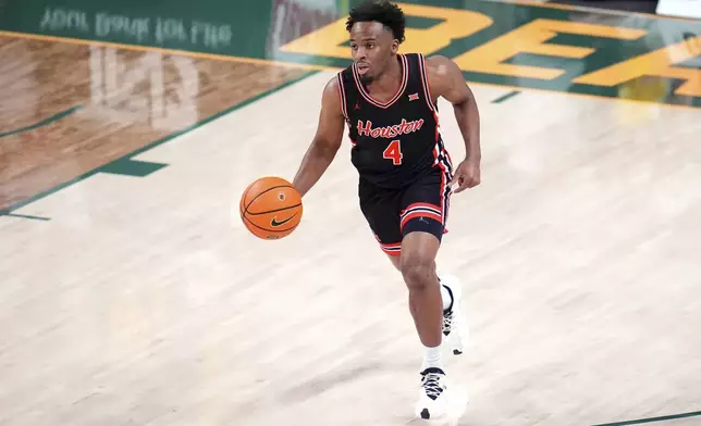 Houston guard L.J. Cryer dribbles the ball up court against the Baylor during the first half of an NCAA college basketball game Saturday, March 8, 2025, in Waco, Texas. (AP Photo/Julio Cortez)