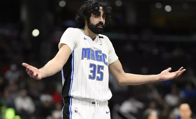 Orlando Magic center Goga Bitadze gestures after he was called for a foul during the first half of an NBA basketball game against the Washington Wizards, Friday, March 21, 2025, in Washington. (AP Photo/Nick Wass)