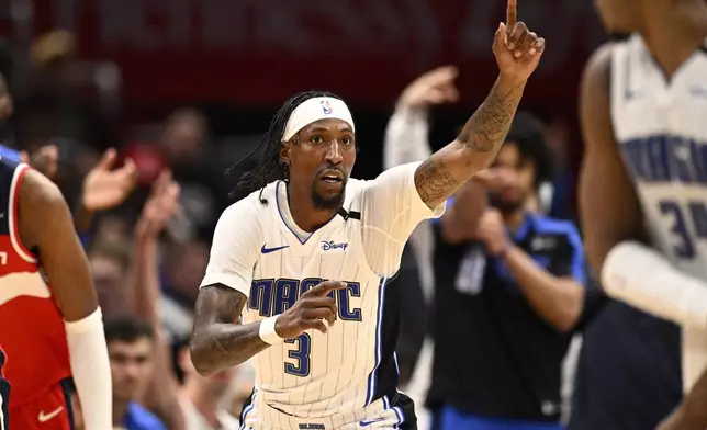 Orlando Magic guard Kentavious Caldwell-Pope (3) gestures after making a 3-point basket during the first half of an NBA basketball game against the Washington Wizards, Friday, March 21, 2025, in Washington. (AP Photo/Nick Wass)