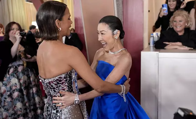 Halle Berry, left, and Michelle Yeoh arrive at the Oscars on Sunday, March 2, 2025, at the Dolby Theatre in Los Angeles. (AP Photo/John Locher)