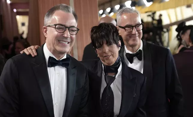 Chief Executive Officer of the Academy of Motion Picture Arts and Sciences, Bill Kramer, from left, Diane Warren and Peter Cipkowsk arrive at the Oscars on Sunday, March 2, 2025, at the Dolby Theatre in Los Angeles. (AP Photo/John Locher)
